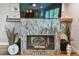 The modern fireplace includes a tile surround, wood mantel, and mounted television at 12020 66Th Ave, Seminole, FL 33772