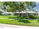 Charming single-story home with stone facade, lush landscaping, and a sidewalk leading to the house at 12020 66Th Ave, Seminole, FL 33772