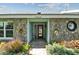 Charming single-story home with stone facade, lush landscaping, and a walkway leading to the front door at 12020 66Th Ave, Seminole, FL 33772