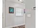 Hallway leading to the bathroom and decorated with modern artwork at 12020 66Th Ave, Seminole, FL 33772