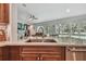 Open kitchen layout featuring granite countertops and stainless steel sink at 12020 66Th Ave, Seminole, FL 33772