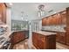 Open kitchen boasts a central island, wood cabinets, granite countertops, and stainless steel appliances at 12020 66Th Ave, Seminole, FL 33772