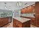 Kitchen with center island, stainless steel appliances, wood cabinets, and granite countertops at 12020 66Th Ave, Seminole, FL 33772