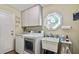 Functional laundry room with modern washer/dryer, utility sink, and ample storage space at 12020 66Th Ave, Seminole, FL 33772