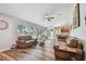 Spacious living room with hardwood floors connects to the kitchen and offers lots of natural light at 12020 66Th Ave, Seminole, FL 33772