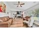 Living room featuring leather furniture, fireplace, and large windows at 12020 66Th Ave, Seminole, FL 33772