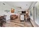 Living room featuring leather furniture, fireplace, and large windows at 12020 66Th Ave, Seminole, FL 33772