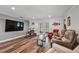 Living room with hardwood floors, a large TV, and comfortable seating area at 12020 66Th Ave, Seminole, FL 33772