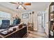 Home office includes hardwood floors, a ceiling fan, built-in shelves, and an en-suite bathroom at 12020 66Th Ave, Seminole, FL 33772