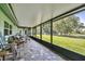 View of the covered patio with outdoor furniture and a view of the large, fenced backyard at 12020 66Th Ave, Seminole, FL 33772
