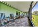 Covered patio with tile flooring, ceiling fan, and comfortable seating area overlooking the backyard at 12020 66Th Ave, Seminole, FL 33772