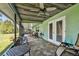 Covered screened porch with ample seating and picturesque views of the green backyard at 12020 66Th Ave, Seminole, FL 33772
