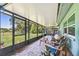 Relaxing screened porch features comfortable seating overlooking the landscaped backyard at 12020 66Th Ave, Seminole, FL 33772