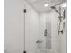 Modern shower features textured white tile, decorative mosaic accents, and a convenient bench at 12020 66Th Ave, Seminole, FL 33772