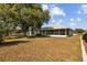 The property has a spacious backyard with screened-in patio and plenty of room for outside activities at 1247 Venetia Dr, Spring Hill, FL 34608