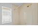 Bathroom shower with tiled walls, shower head, and window at 1247 Venetia Dr, Spring Hill, FL 34608