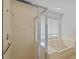 Bathroom with a glass shower, shower head, tub and window at 1247 Venetia Dr, Spring Hill, FL 34608