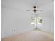 Bright bedroom with a ceiling fan and natural light from the two windows at 1247 Venetia Dr, Spring Hill, FL 34608
