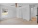 Bedroom featuring carpet flooring, closet doors, and a window at 1247 Venetia Dr, Spring Hill, FL 34608