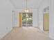Bright dining room featuring neutral carpet, sliding glass doors to the outside, and bright lighting at 1247 Venetia Dr, Spring Hill, FL 34608