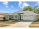 Charming single-story home with a manicured lawn, well-maintained landscaping, and a two-car garage at 1247 Venetia Dr, Spring Hill, FL 34608