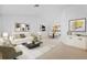 Bright living room featuring neutral tones, modern art, comfortable seating, and an adjacent dining area at 1247 Venetia Dr, Spring Hill, FL 34608