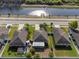 Aerial view of homes with manicured lawns, fenced yards, and waterway views at 12620 Flatwood Creek Dr, Gibsonton, FL 33534
