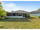 Manicured backyard with a screened lanai and lush landscaping at 12620 Flatwood Creek Dr, Gibsonton, FL 33534