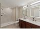 Modern bathroom with double vanity, updated lighting and step in shower at 12620 Flatwood Creek Dr, Gibsonton, FL 33534