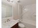 Clean bathroom featuring marble wall tiles, shower/tub combo, vanity and natural light at 12620 Flatwood Creek Dr, Gibsonton, FL 33534