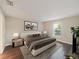 Spacious main bedroom with a large window, wood floors, and decorative artwork above the bed at 12620 Flatwood Creek Dr, Gibsonton, FL 33534