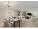 Open-concept dining room featuring a modern table, a decorative chandelier, and views of living area at 12620 Flatwood Creek Dr, Gibsonton, FL 33534