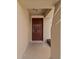 An inviting recessed entryway with a six-panel door and space for outdoor decor at 12620 Flatwood Creek Dr, Gibsonton, FL 33534