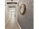 A hallway with decorative walls, recessed lighting, and access to kitchen and living room at 12620 Flatwood Creek Dr, Gibsonton, FL 33534
