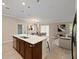 Open kitchen area with a marble-top island, stainless steel appliances, and an open view to the dining room at 12620 Flatwood Creek Dr, Gibsonton, FL 33534