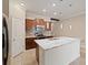 An eat-in kitchen with a central island, wood cabinets, stainless steel appliances, and recessed lighting at 12620 Flatwood Creek Dr, Gibsonton, FL 33534
