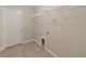Bright laundry room featuring tile flooring, overhead rack and utility connections for modern convenience at 12620 Flatwood Creek Dr, Gibsonton, FL 33534