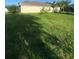Lush green backyard of single-story home with well-manicured lawn at 13181 Royal Pines Ave, Riverview, FL 33579