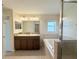 Bathroom with dual sinks, a soaking tub, a glass-enclosed shower, and neutral color scheme at 13181 Royal Pines Ave, Riverview, FL 33579