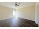 Bedroom features a ceiling fan, wood-look floors, and a sunlit window at 13181 Royal Pines Ave, Riverview, FL 33579