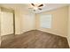 Clean bedroom featuring wood-look flooring, a closet, and natural light from the window at 13181 Royal Pines Ave, Riverview, FL 33579