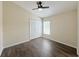 Bright bedroom featuring wood-look floors, a window and double closet doors at 13181 Royal Pines Ave, Riverview, FL 33579