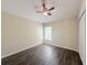 Bedroom with a ceiling fan, wood floors, a closet, and a window for natural lighting at 13181 Royal Pines Ave, Riverview, FL 33579