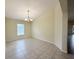 Dining room featuring neutral walls, a modern chandelier, and large window with natural light at 13181 Royal Pines Ave, Riverview, FL 33579