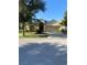 Charming single-story home with a well-maintained lawn, mature trees, and a two-car garage at 13181 Royal Pines Ave, Riverview, FL 33579
