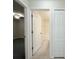 Hallway view of a bedroom and a bathroom with a tiled tub and shower combo at 13181 Royal Pines Ave, Riverview, FL 33579