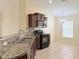 Kitchen featuring granite countertops, a stainless steel oven, and a microwave at 13181 Royal Pines Ave, Riverview, FL 33579