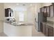 Kitchen with granite countertops, stainless steel appliances, and dark wood cabinets at 13181 Royal Pines Ave, Riverview, FL 33579