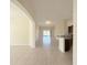 Spacious living area featuring tiled floors, arched doorways, and seamless flow to the kitchen at 13181 Royal Pines Ave, Riverview, FL 33579
