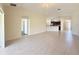Open-concept floor plan with tile flooring, arched doorways, and a view of the kitchen at 13181 Royal Pines Ave, Riverview, FL 33579